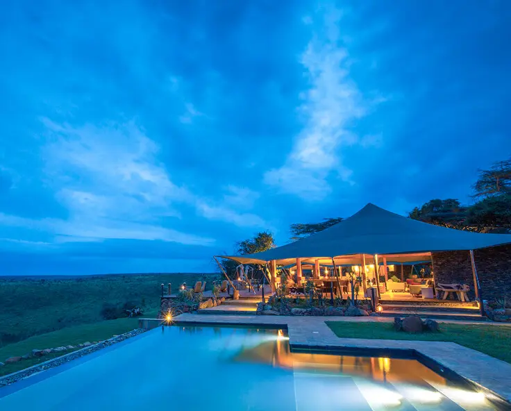 Loisaba Tented Camp at night with view of the pool